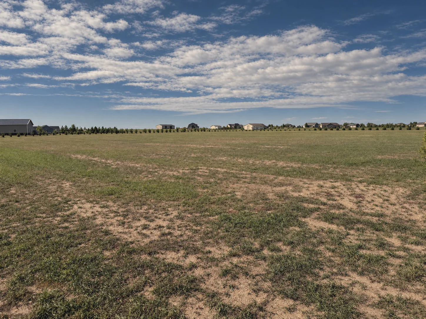 The Preserve's shared open space under a wide Wyoming sky, homes along the horizon